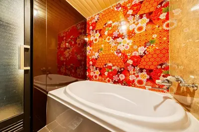 a bathroom with a sink and a mosaic wall at HOTEL Lotus Ikebukuro (Adult Only) in Tokyo