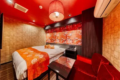 a bedroom with a bed and a couch and a chair at HOTEL Lotus Ikebukuro (Adult Only) in Tokyo