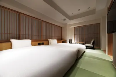 a large white bed in a hotel room at PROSTYLE RYOKAN TOKYO ASAKUSA in Tokyo
