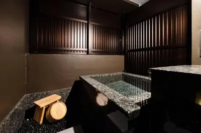 a bathroom with a glass tub with a toilet at PROSTYLE RYOKAN TOKYO ASAKUSA in Tokyo
