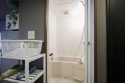 a small kitchen with a sink and a white refrigerator at Akabane TK Building 102 in Tokyo