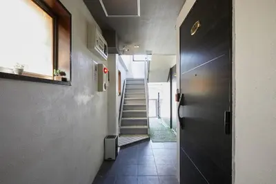 a hallway with a stairway with a door and a stair case at Akabane TK Building 102 in Tokyo