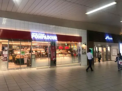 a man walking in front of a store at Akabane TK Building 102 in Tokyo