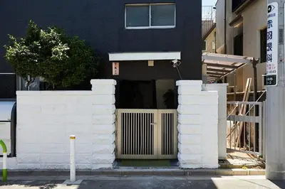 a building with white walls and a white fence at Akabane TK Building 103 in Tokyo