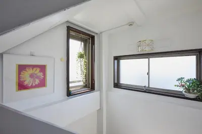 a white room with two windows and a picture at Akabane TK Building 103 in Tokyo