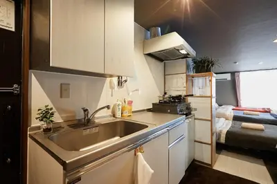 a small kitchen with a sink and a room at Akabane TK Building 103 in Tokyo