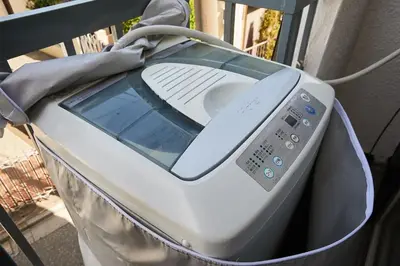 a washing machine sitting on top of a balcony at Akabane TK Building 103 in Tokyo