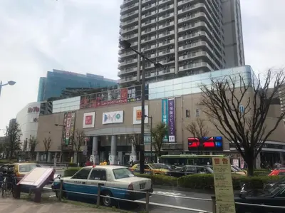a police car parked in front of a large building at Akabane TK Building 201 in Tokyo