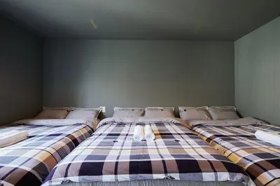two beds sitting next to each other in a room at Akabane TK Building 202 in Tokyo