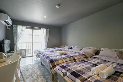 two beds sitting in a room with a window at Akabane TK Building 202 in Tokyo