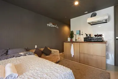 a bedroom with a bed and a kitchen at Akabane TK Building 203 in Tokyo