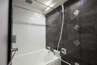 a shower with a glass door in a bathroom at Akabane TK Building 203 in Tokyo