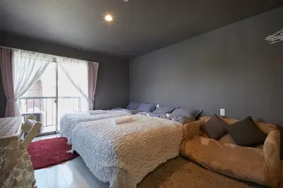 a bedroom with a large bed and a couch at Akabane TK Building 203 in Tokyo