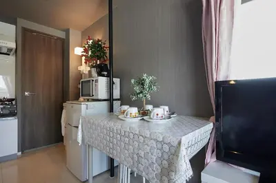 a kitchen with a table with cups and plates on it at Akabane TK Building 301 in Tokyo