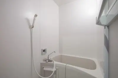 a white bathroom with a shower and a sink at Akabane TK Building 301 in Tokyo