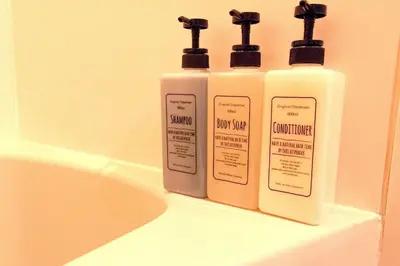 two bottles of soap and shampoo sitting on a bathroom sink at Akabane TK Building 302 in Tokyo