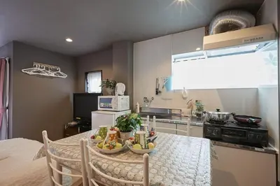 a kitchen with a table with a bowl of fruit on it at Akabane TK Building 303 in Tokyo