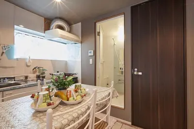a kitchen with a table with fruits and vegetables on it at Akabane TK Building 303 in Tokyo