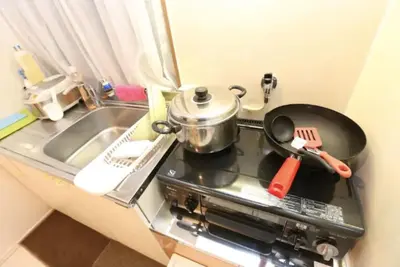 a kitchen stove with a pot and a pan on it at Kamiya TK Building 201 in Tokyo