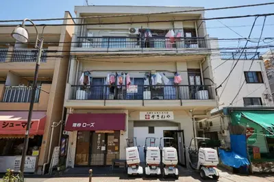 a building with clothes hanging on a balcony at Kamiya TK Building 201 in Tokyo