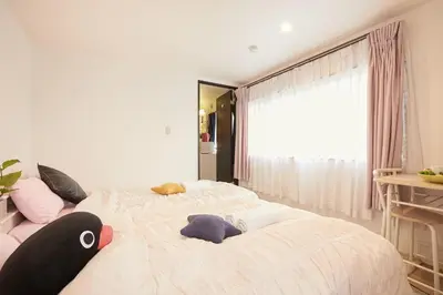 a bedroom with a large bed with stuffed animals on it at Kamiya TK Building 203 in Tokyo