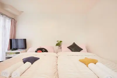 a bedroom with two beds with stuffed animals on them at Kamiya TK Building 203 in Tokyo