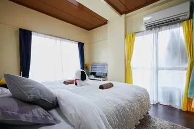 a bedroom with a bed with a stuffed animal on it at Kamiya TK Building 301 in Tokyo