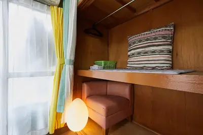 a room with a shelf and a pillow and a window at Kamiya TK Building 301 in Tokyo