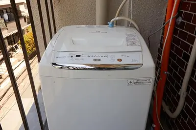 a washing machine sitting on top of a refrigerator at Kamiya TK Building 301 in Tokyo
