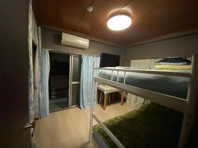 a room with two bunk beds and a window at Kamiya TK Building 302 in Tokyo