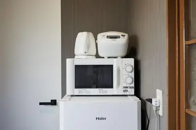a microwave and a blender on top of a refrigerator at Kamiya TK Building 302 in Tokyo