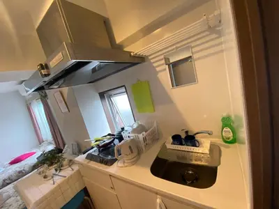 a small kitchen with a sink and a stove at Takemura Building 301 in Tokyo