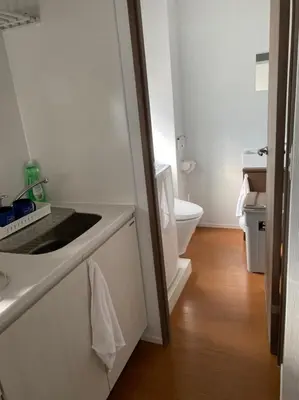 a bathroom with a sink and a toilet at Takemura Building 301 in Tokyo
