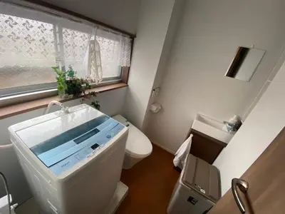 a small bathroom with a toilet and a window at Takemura Building 301 in Tokyo