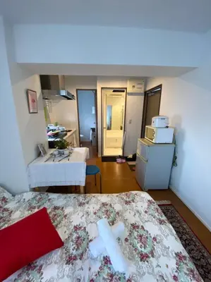 a room with a bed and a bathroom with a sink at Takemura Building 301 in Tokyo