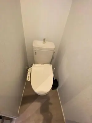 a small bathroom with a white toilet in a corner at Takemura Building 302 in Tokyo