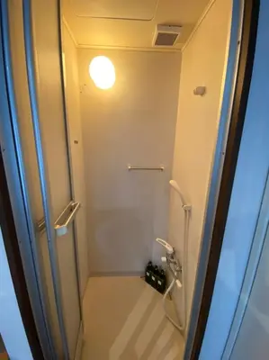 a bathroom with a shower with a glass door at Takemura Building 302 in Tokyo