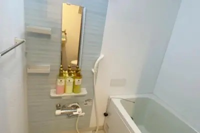 a bathroom with a sink and a tub and a mirror at Takemura Building 104 in Tokyo