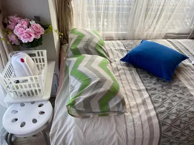 a bed with a pillow and a basket of flowers at Takemura Building 303 in Tokyo