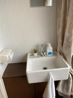 a white sink in a bathroom with a mirror at Takemura Building 303 in Tokyo