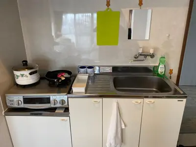 a kitchen with a sink and a stove at Takemura Building 303 in Tokyo