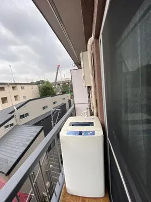 a balcony with a refrigerator and a cooler at Takemura Building 3F in Tokyo