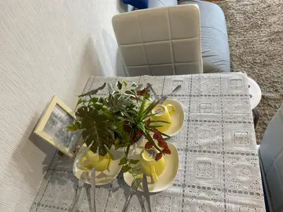 a table with a vase of flowers on a table at Takemura Building 3F in Tokyo