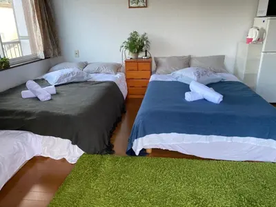 two beds with pillows on them in a bedroom at Takemura Building 305 in Tokyo