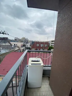a trash can sitting on the balcony of a building at Takemura Building 305 in Tokyo