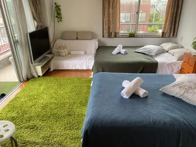 two beds in a room with two towels on them at Takemura Building 305 in Tokyo