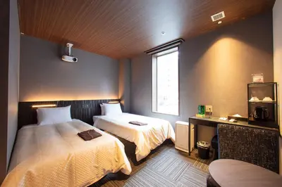 a hotel room with two beds and a window at JHotelTokyoGEO in Tokyo