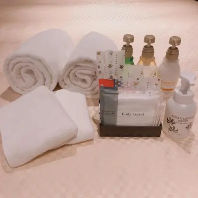 a pile of towels and hygiene products on a bed at JHotelTokyoGEO in Tokyo