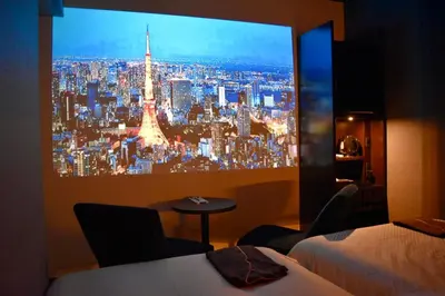 a room with two beds and a view of a city at JHotelTokyoGEO in Tokyo