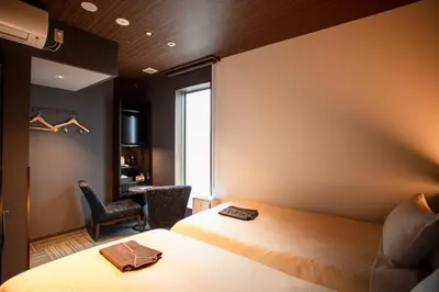 a hotel room with a bed and a window at JHotelTokyoGEO in Tokyo